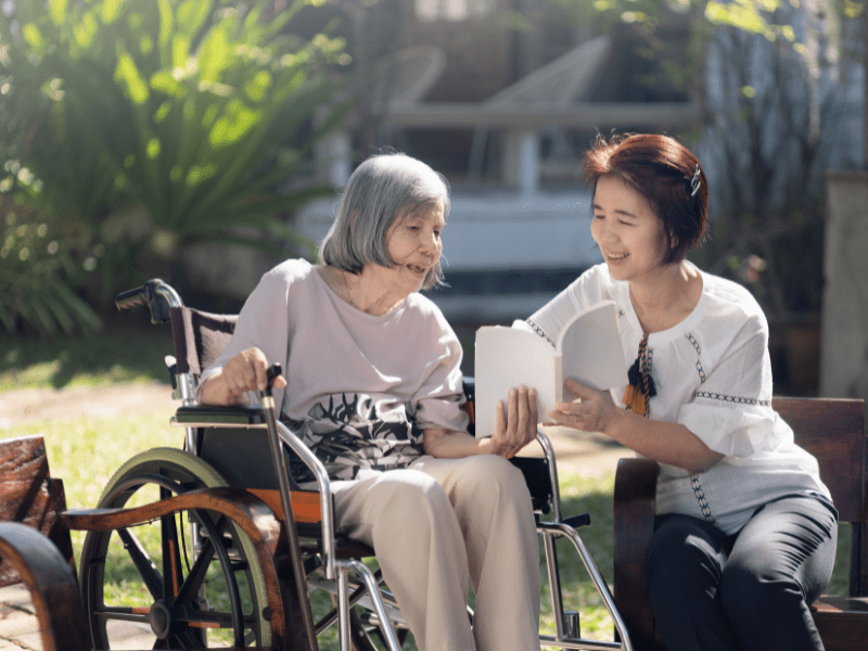 Caregiver Reading to Senior to Reduce Anxiety