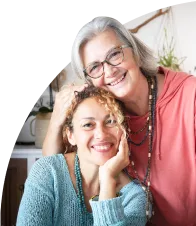 young caregiver and older woman smiling